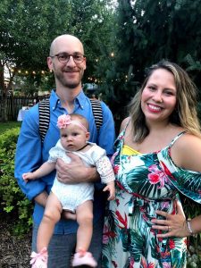 Family of three posing for photo in spring clothes